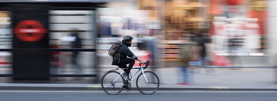 Man cycling through city street