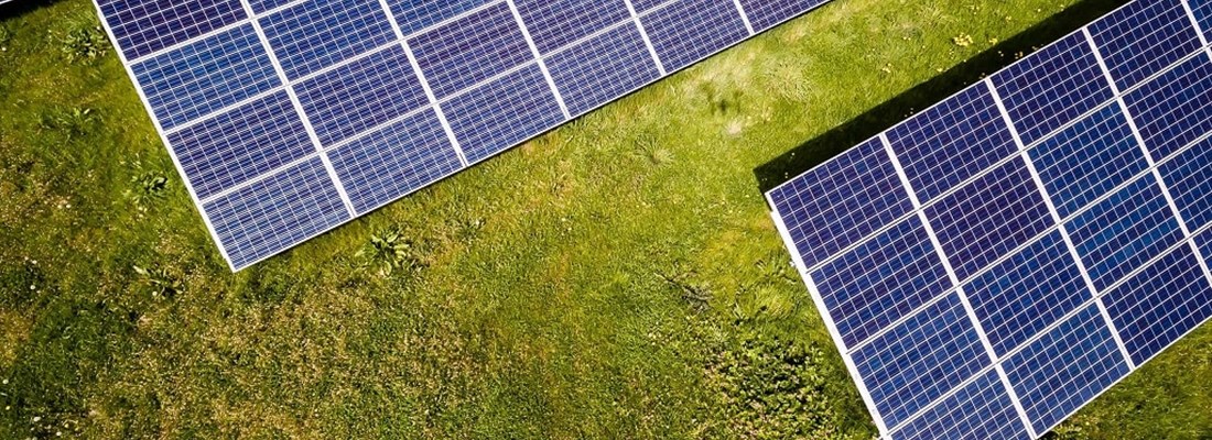 Solar panels on a green field.